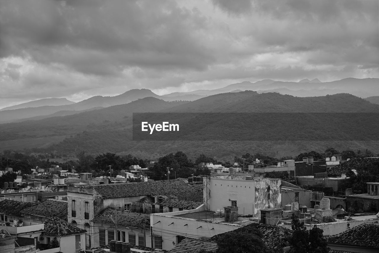 High angle view of houses in town against sky