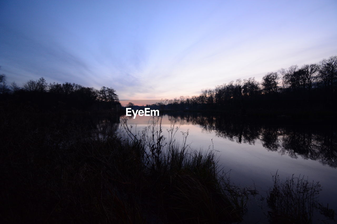 Scenic view of lake against sky during sunset