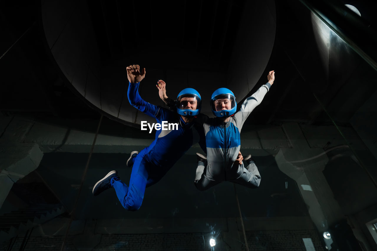 Portrait of couple skydiving in tunnel