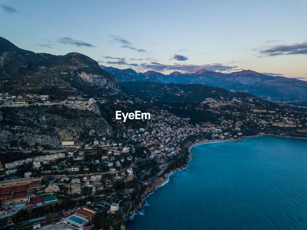 High angle view of sea and mountains against sky