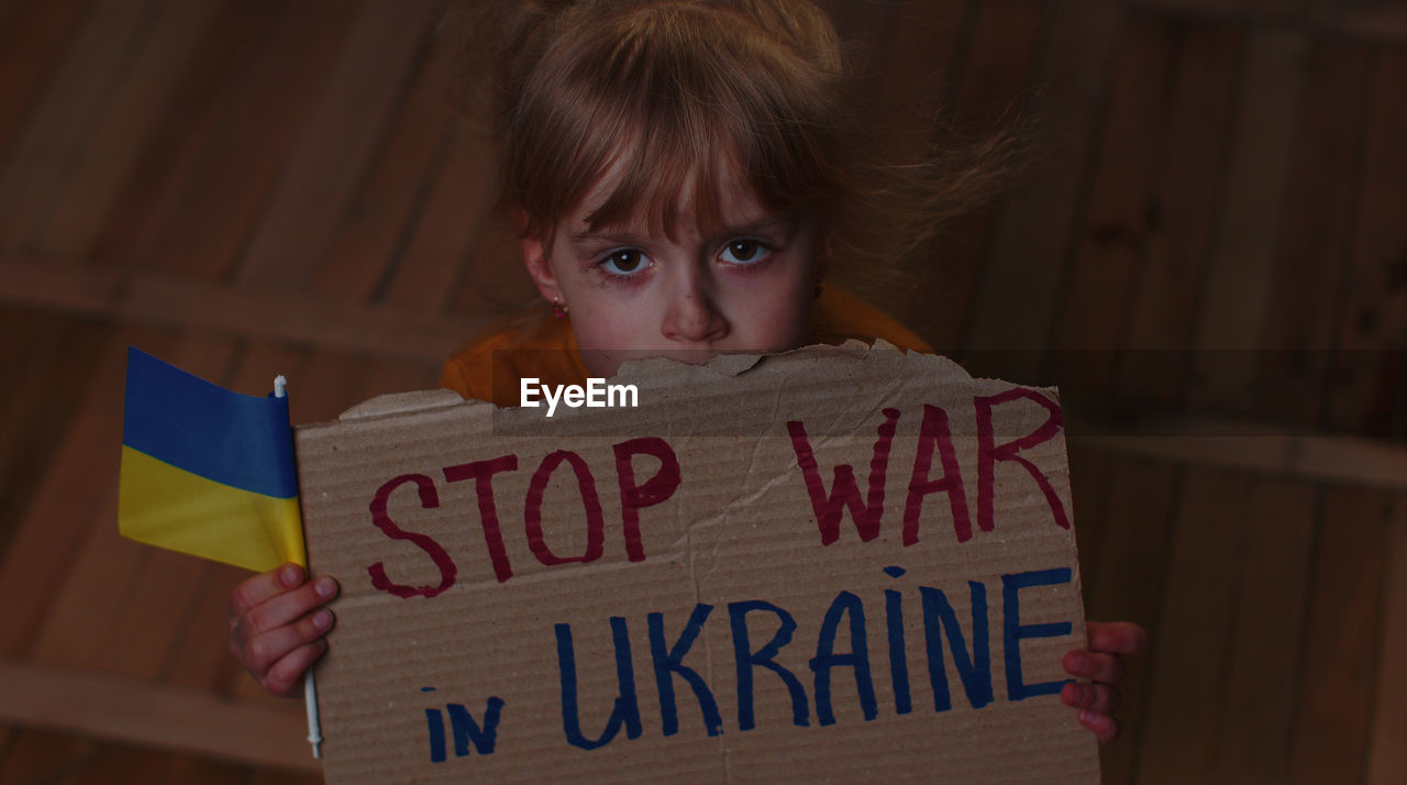 high angle view of young woman holding text on table