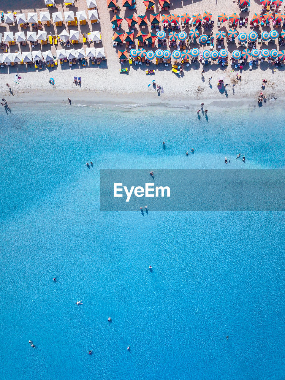 High angle view of people at beach on sunny day