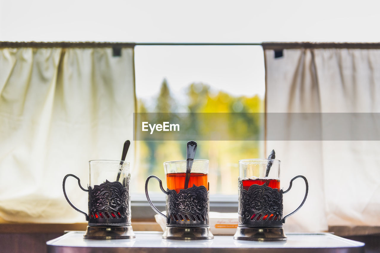 Black tea in glasses on table at cafe