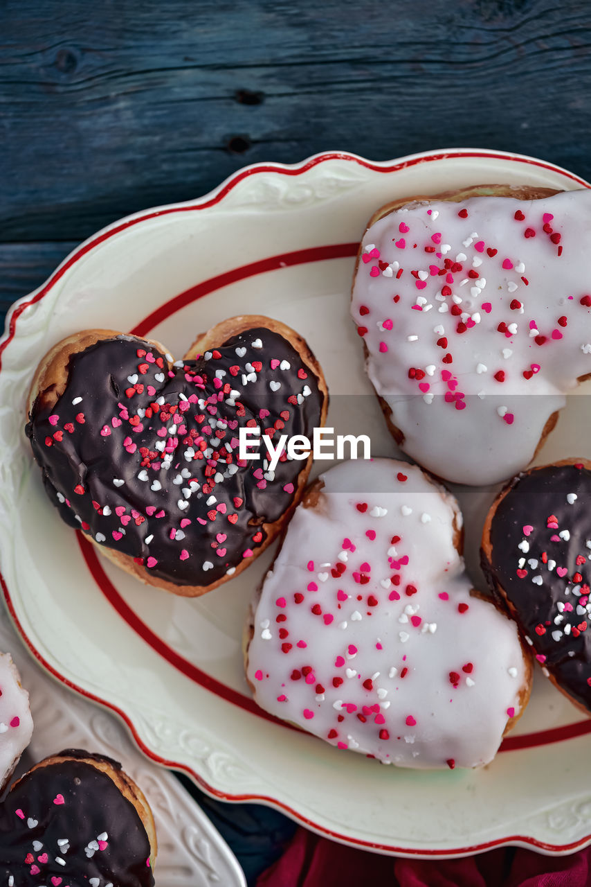 Valentines day chocolate and vanilla heart donuts with colorful tiny heart sprinkles