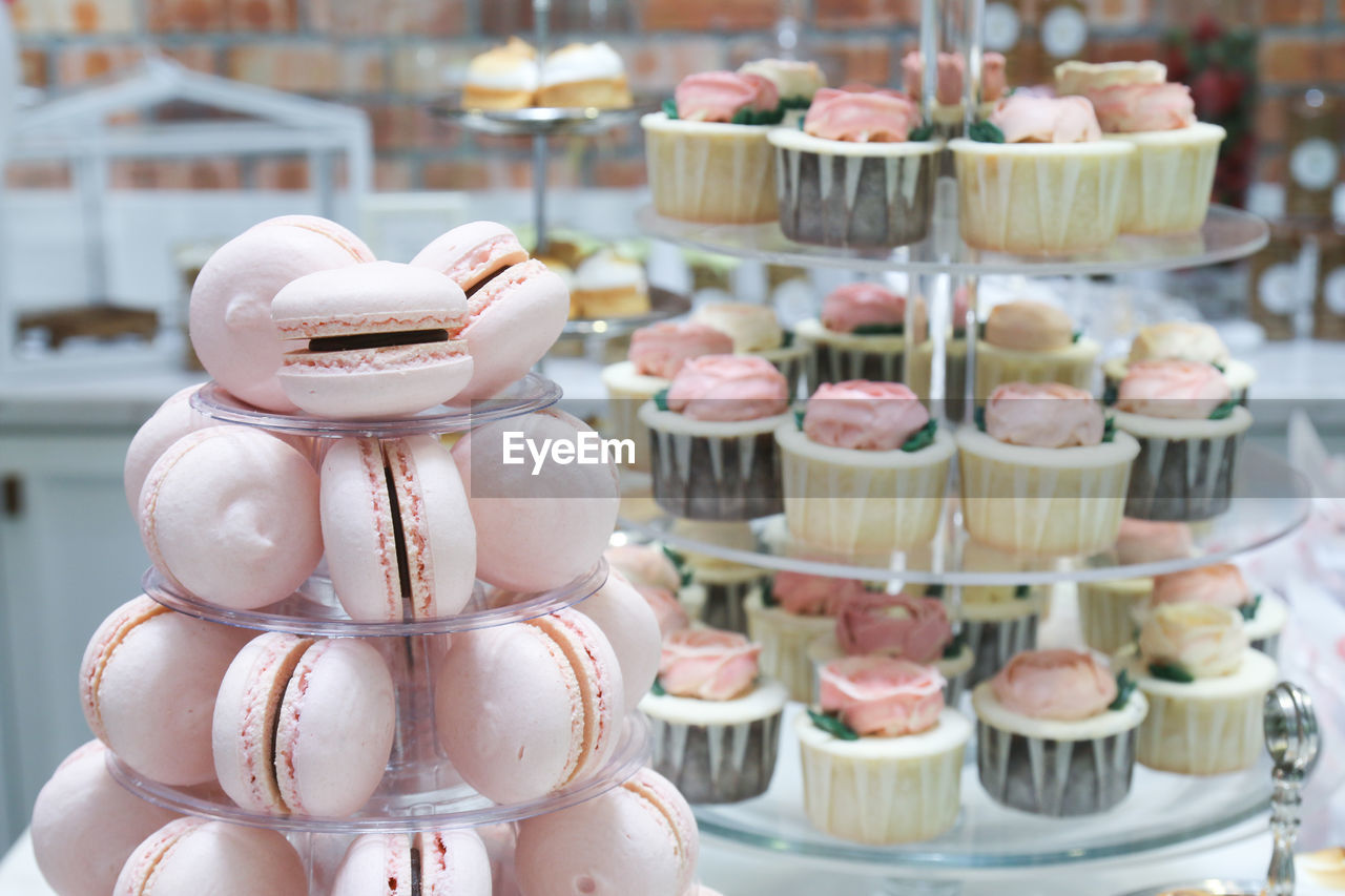 Close-up of macaroons with cupcakes arranged in party