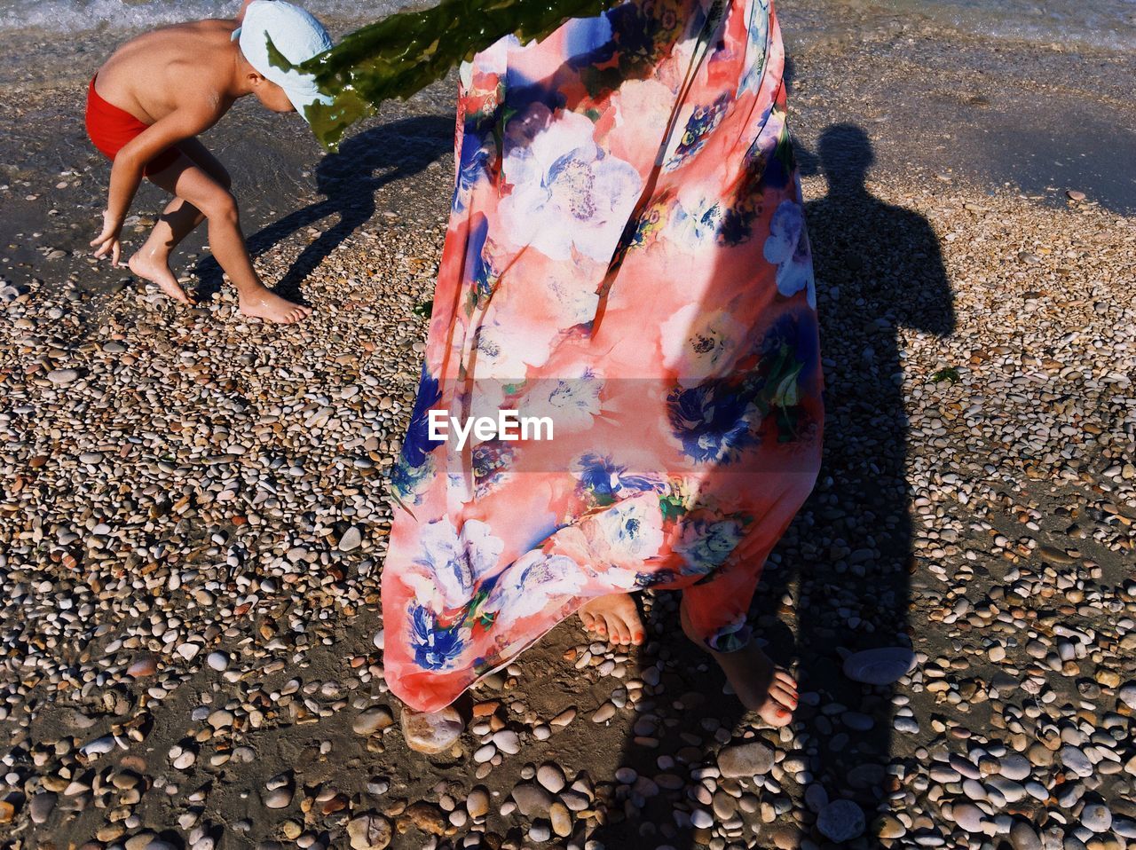 Low section of woman walking on shore