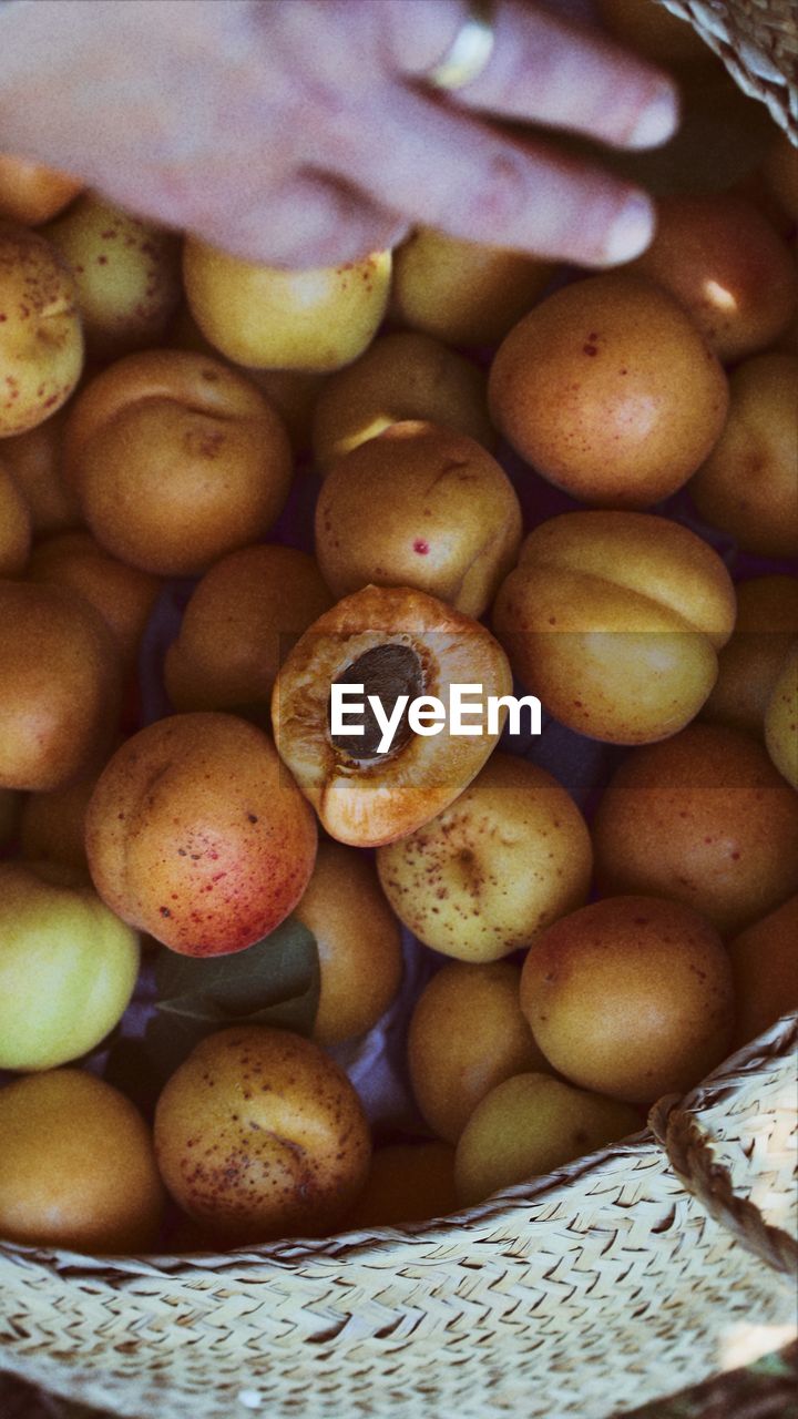 HIGH ANGLE VIEW OF FRUITS IN BASKET AT MARKET STALL