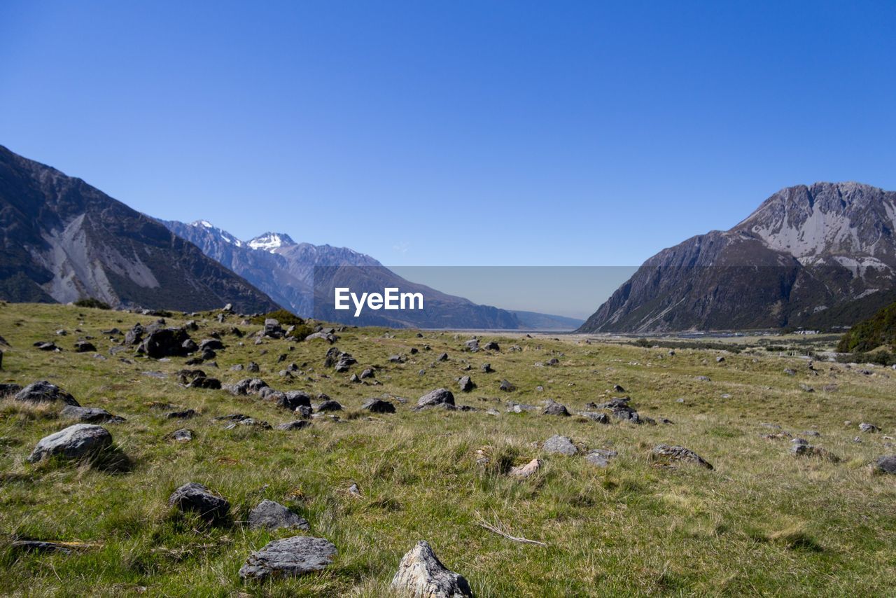 Scenic view of mountains against clear blue sky