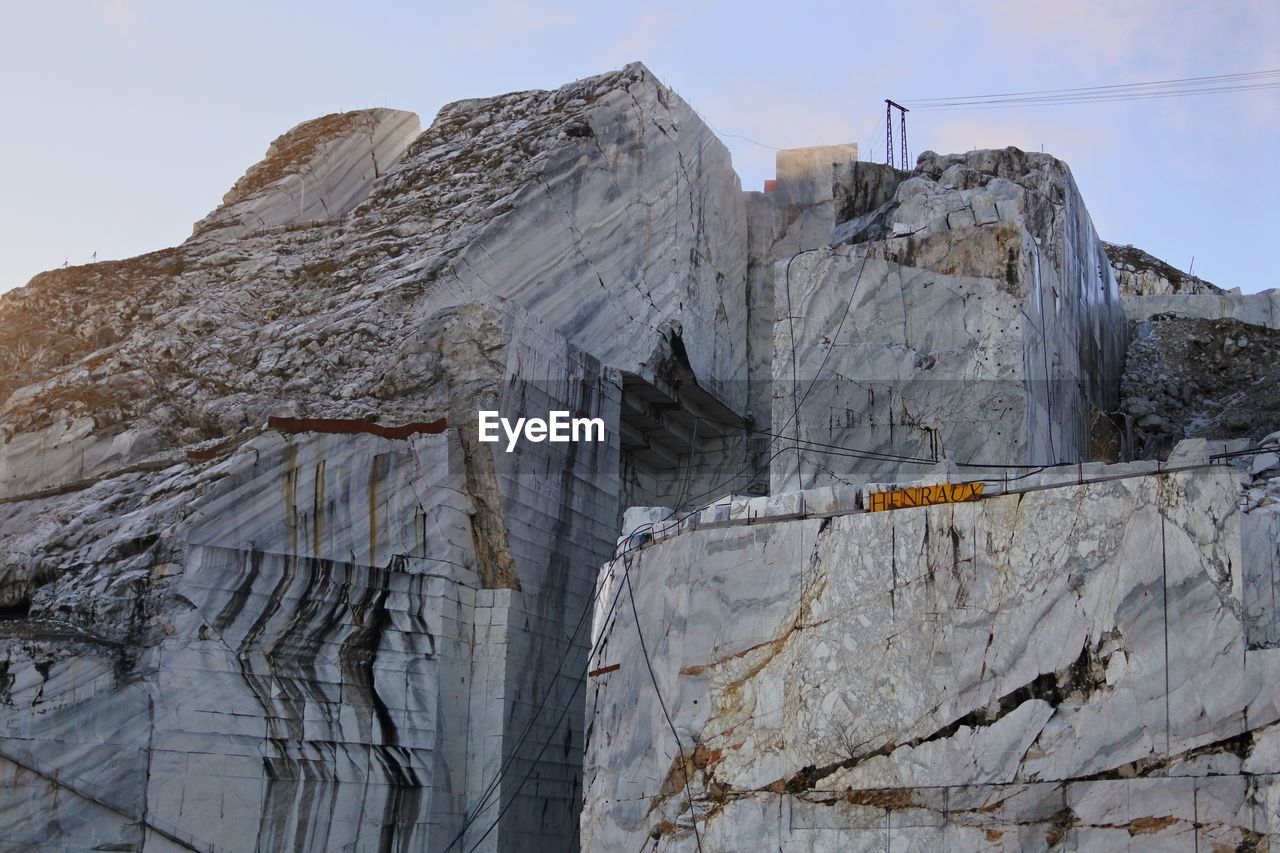 Low angle view of rock formation against sky