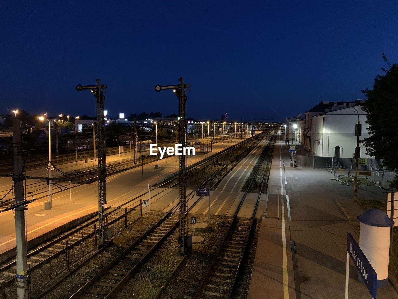 Railroad tracks in city at night