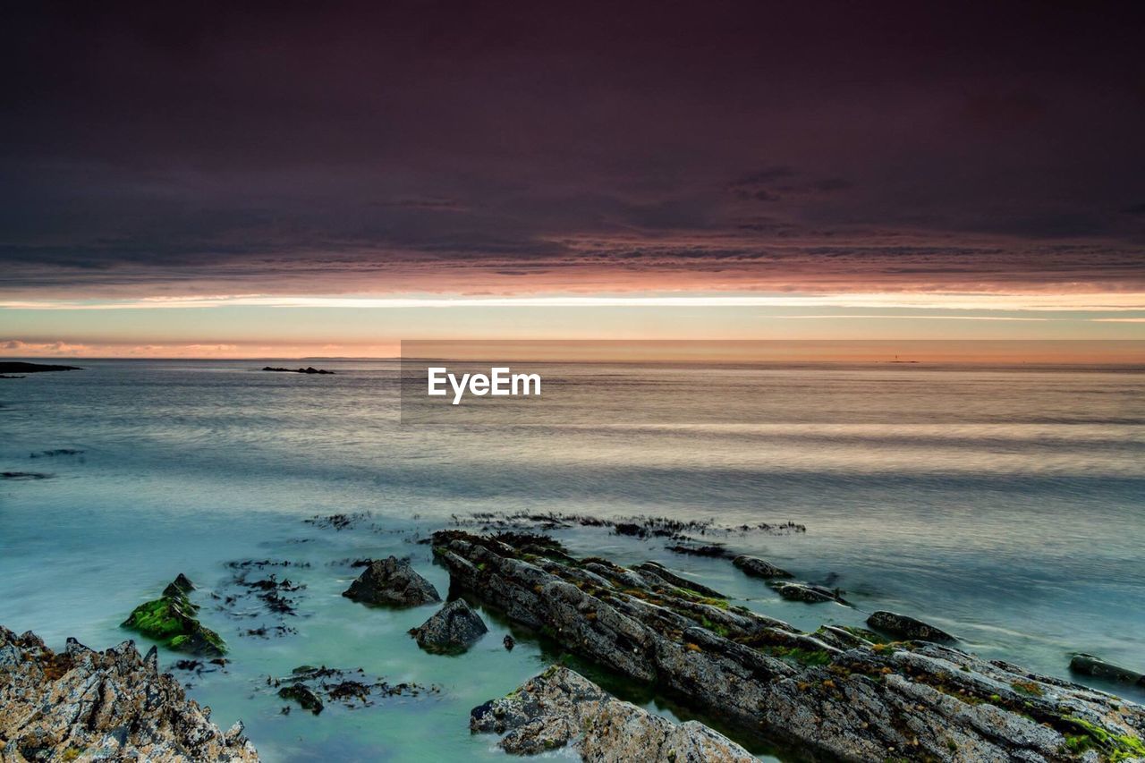 Scenic view of sea against cloudy sky