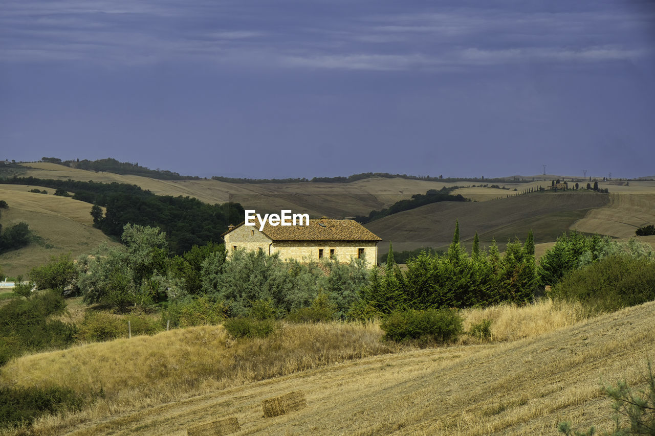 houses on landscape against sky