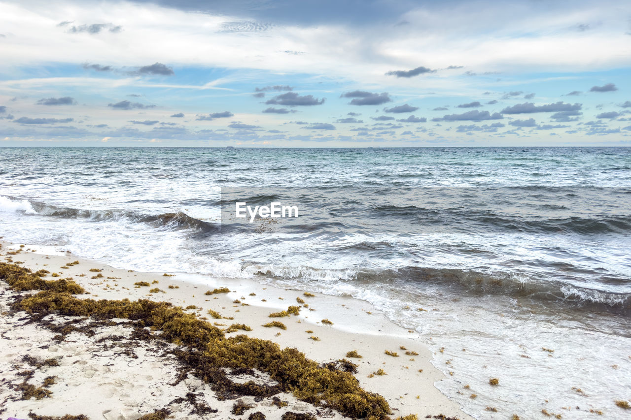 scenic view of sea against cloudy sky