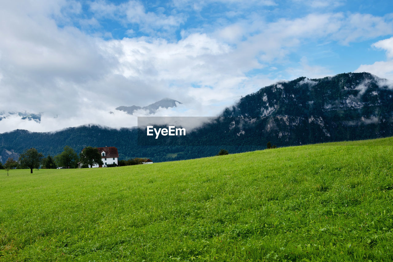 Beautiful green mountains landscape in switzerland alps. small house