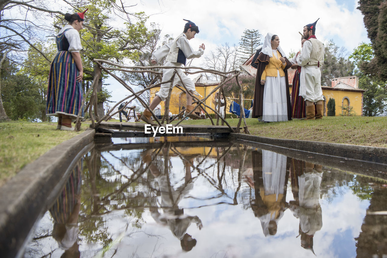 REFLECTION OF PEOPLE IN WATER