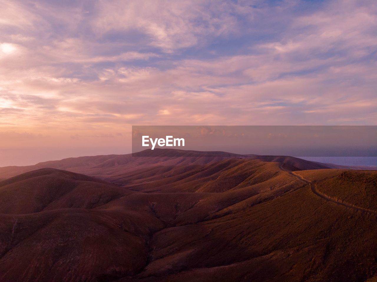 Scenic view of landscape against sky during sunset