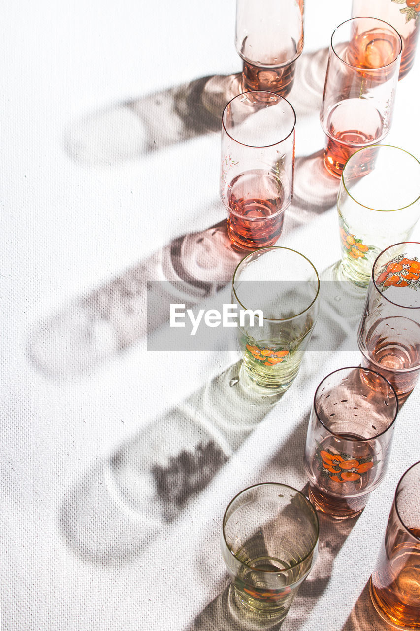 High angle of glasses with back light and beautiful shadows on the white background. copy space