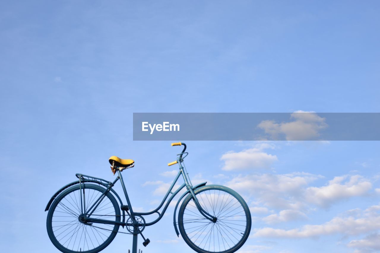 Close-up of bicycle against blue sky