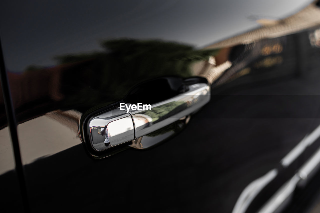 Car door handle on driver's door of modern black car. high quality photo.