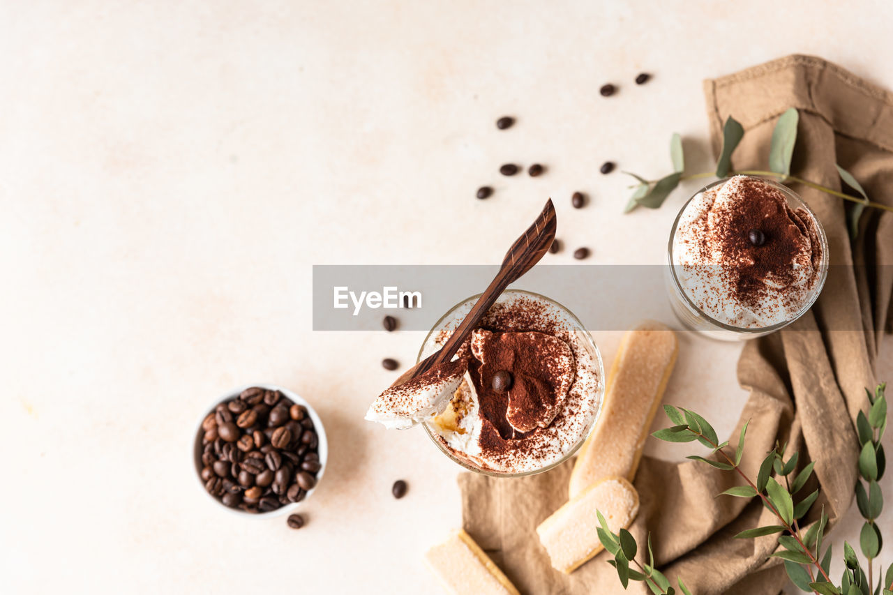 food and drink, food, drink, spice, freshness, indoors, coffee, studio shot, refreshment, high angle view, still life, wood, no people, table, ingredient, roasted coffee bean, copy space, healthy eating, cup, brown, cinnamon, directly above, produce, mug, hot drink, wellbeing, kitchen utensil