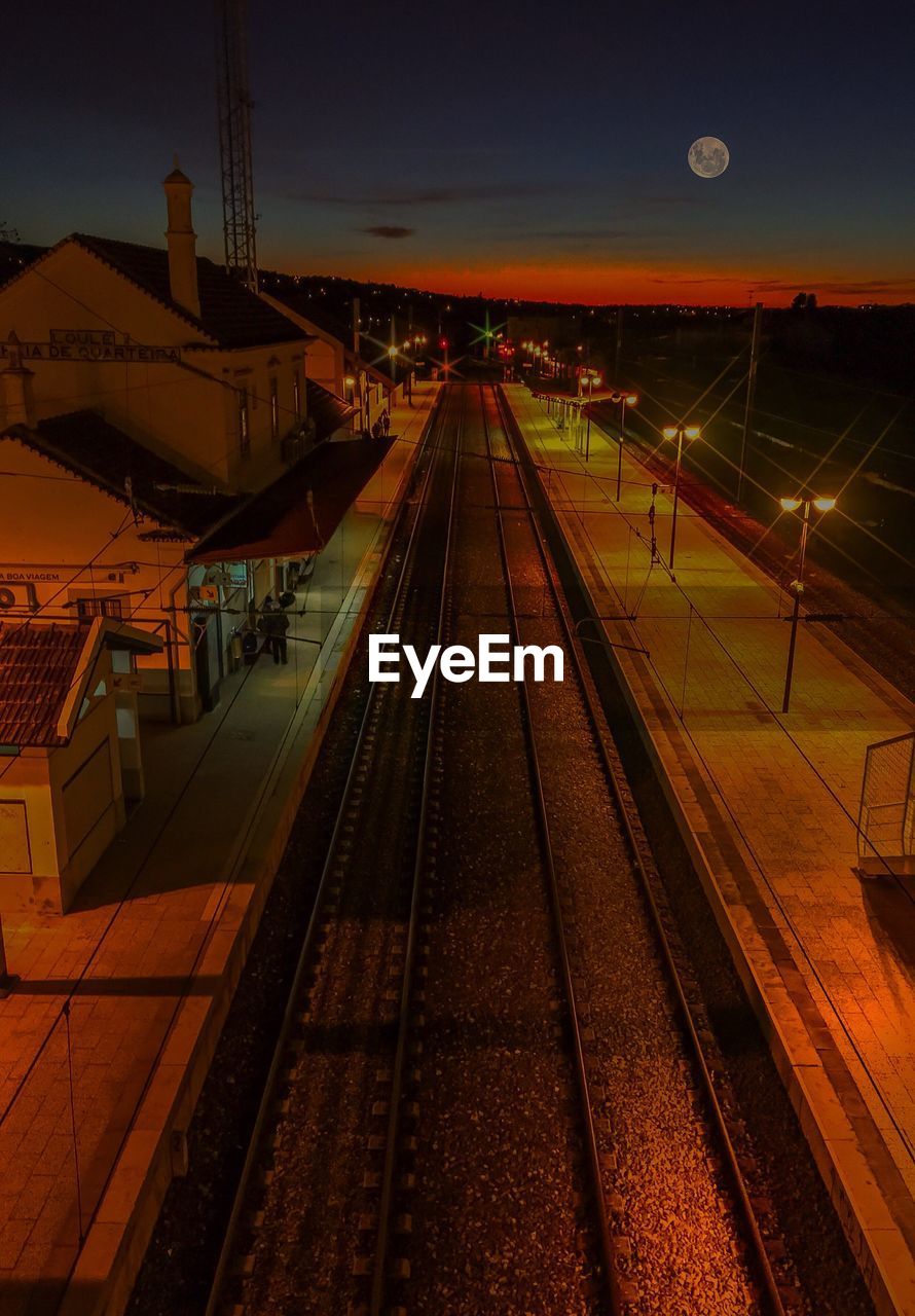 HIGH ANGLE VIEW OF RAILROAD TRACKS AT NIGHT