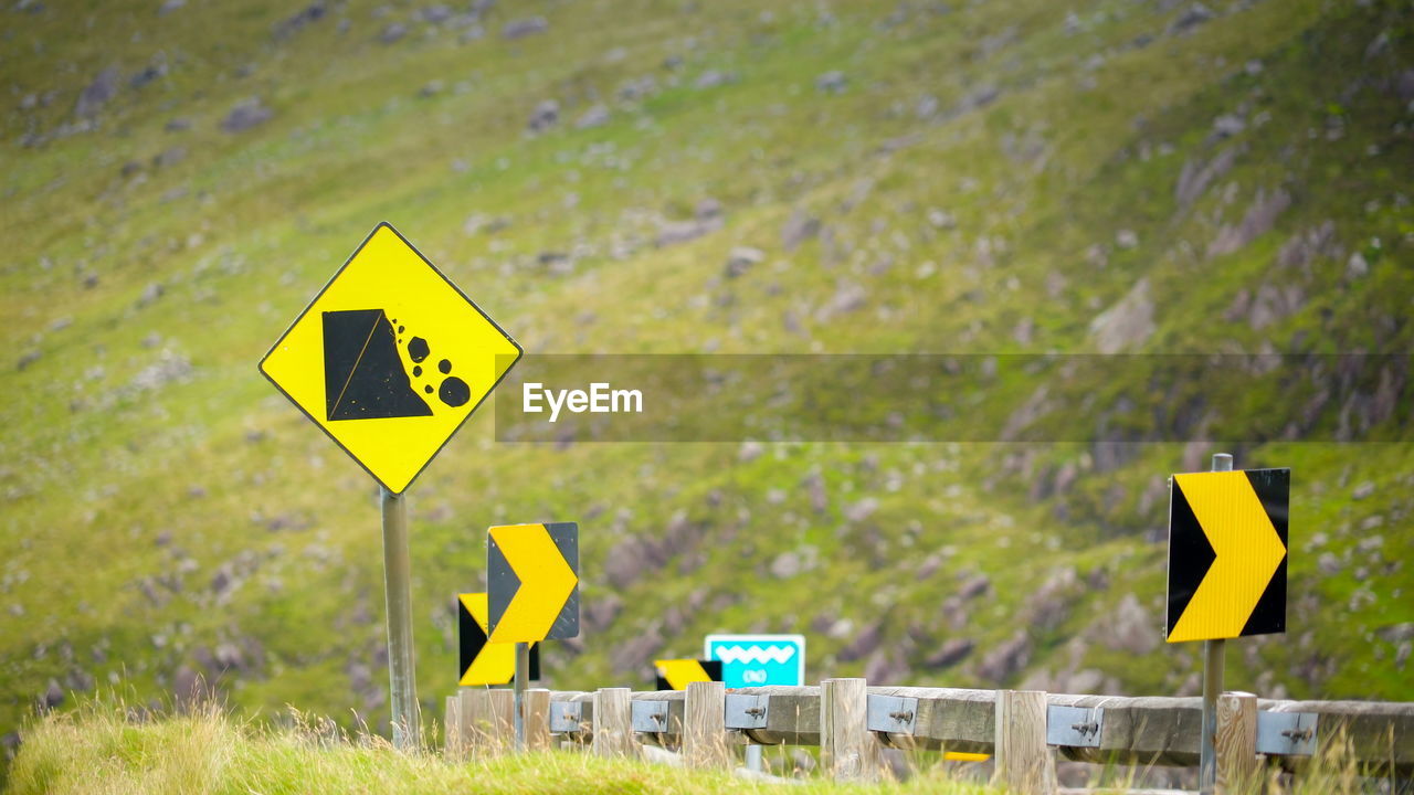 INFORMATION SIGN ON ROAD BY PLANTS