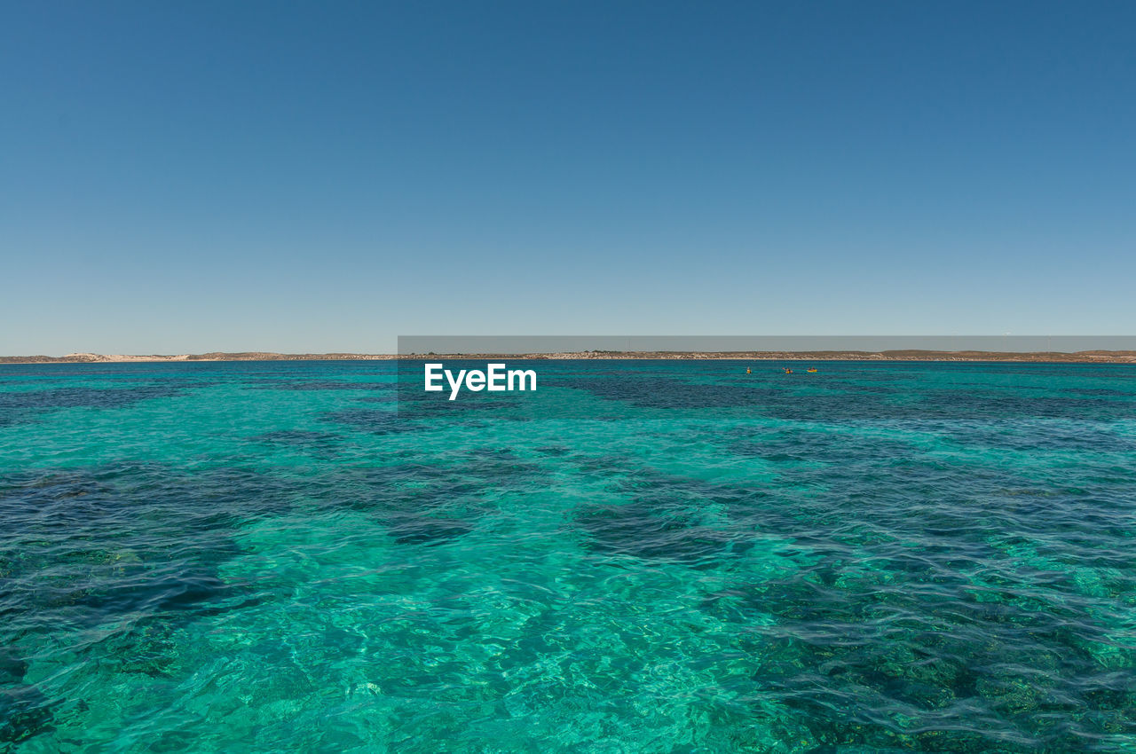 View of sea against clear blue sky