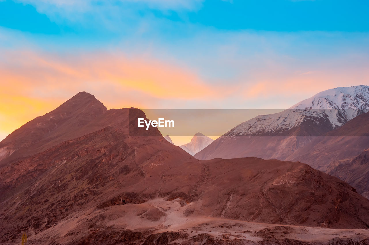 Scenic view of mountains against sky during sunset