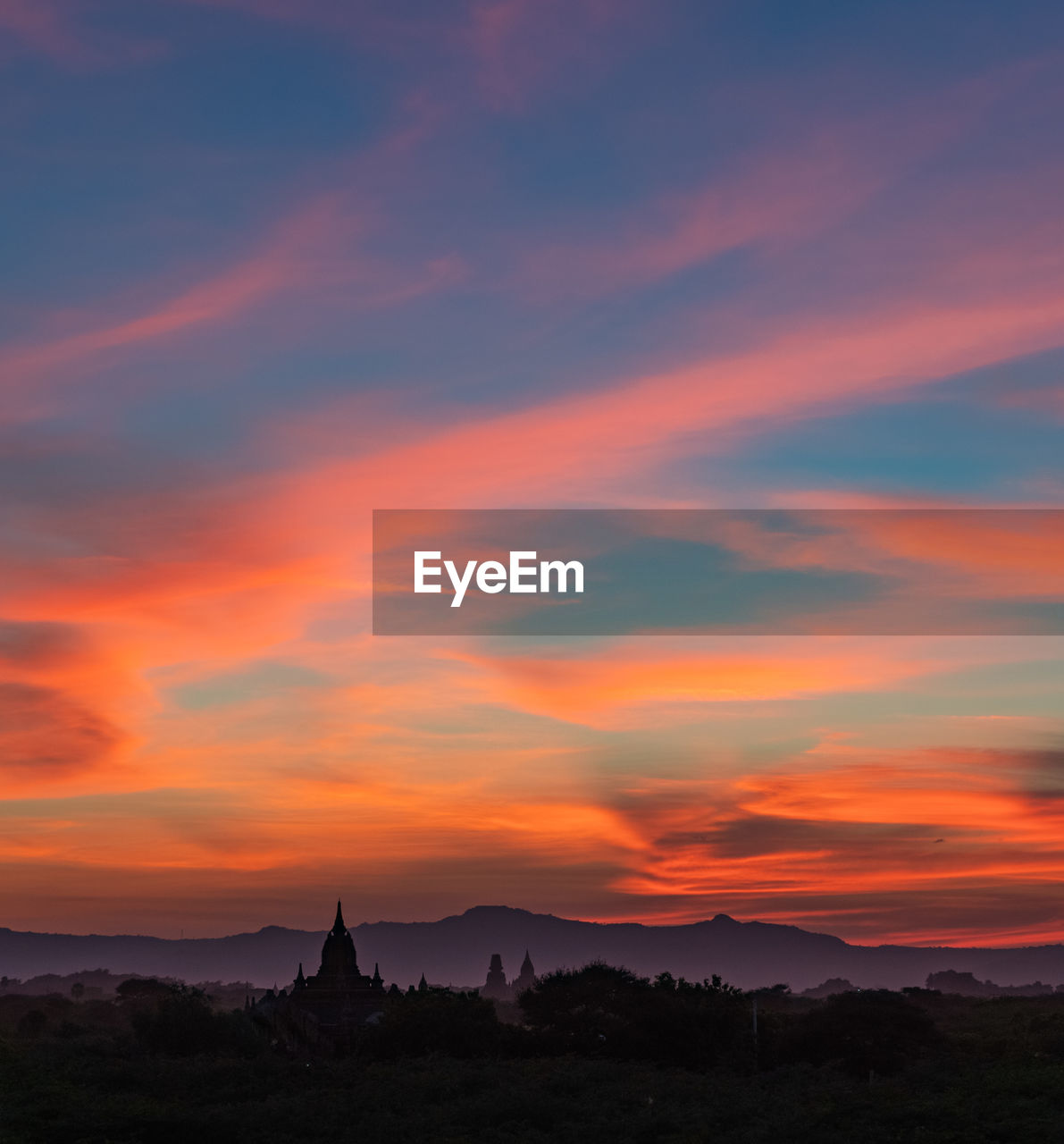 SILHOUETTE TEMPLE AGAINST ORANGE SKY