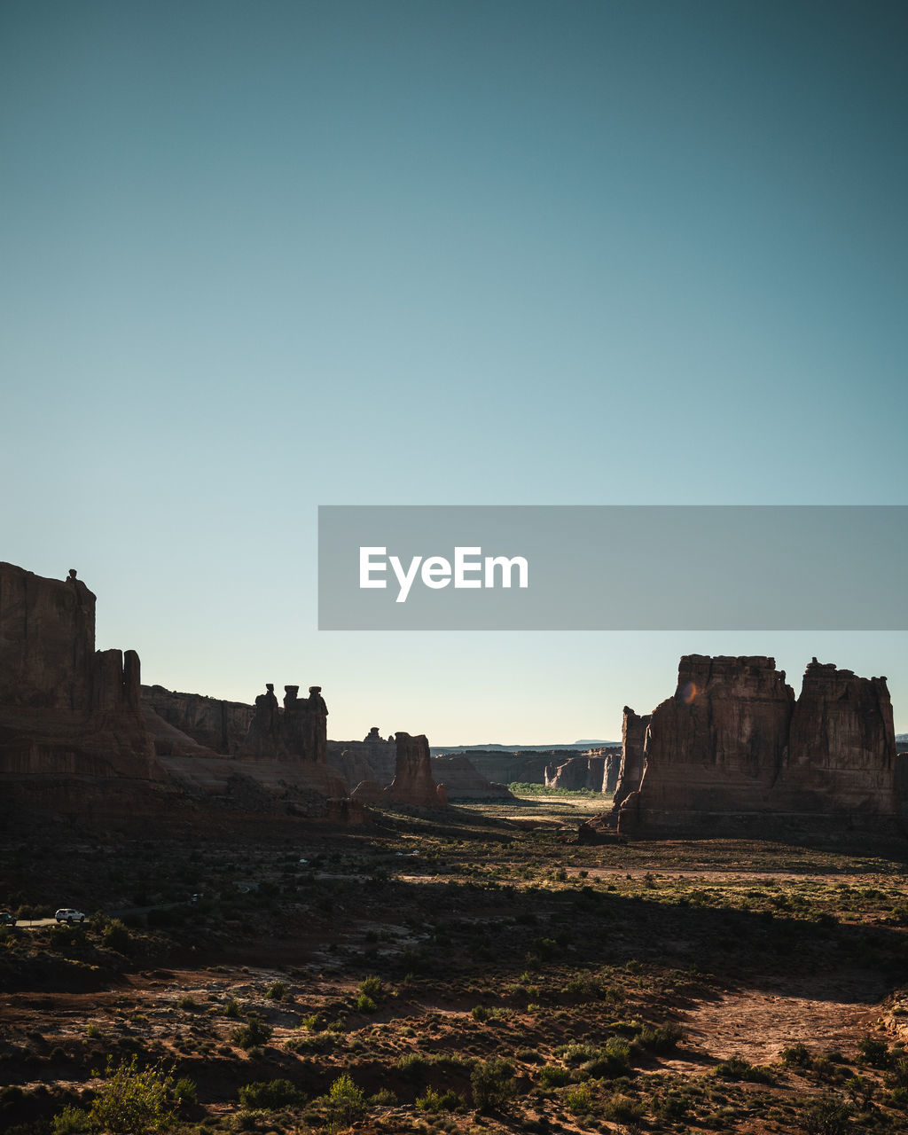 PANORAMIC VIEW OF ROCK FORMATIONS AGAINST CLEAR SKY