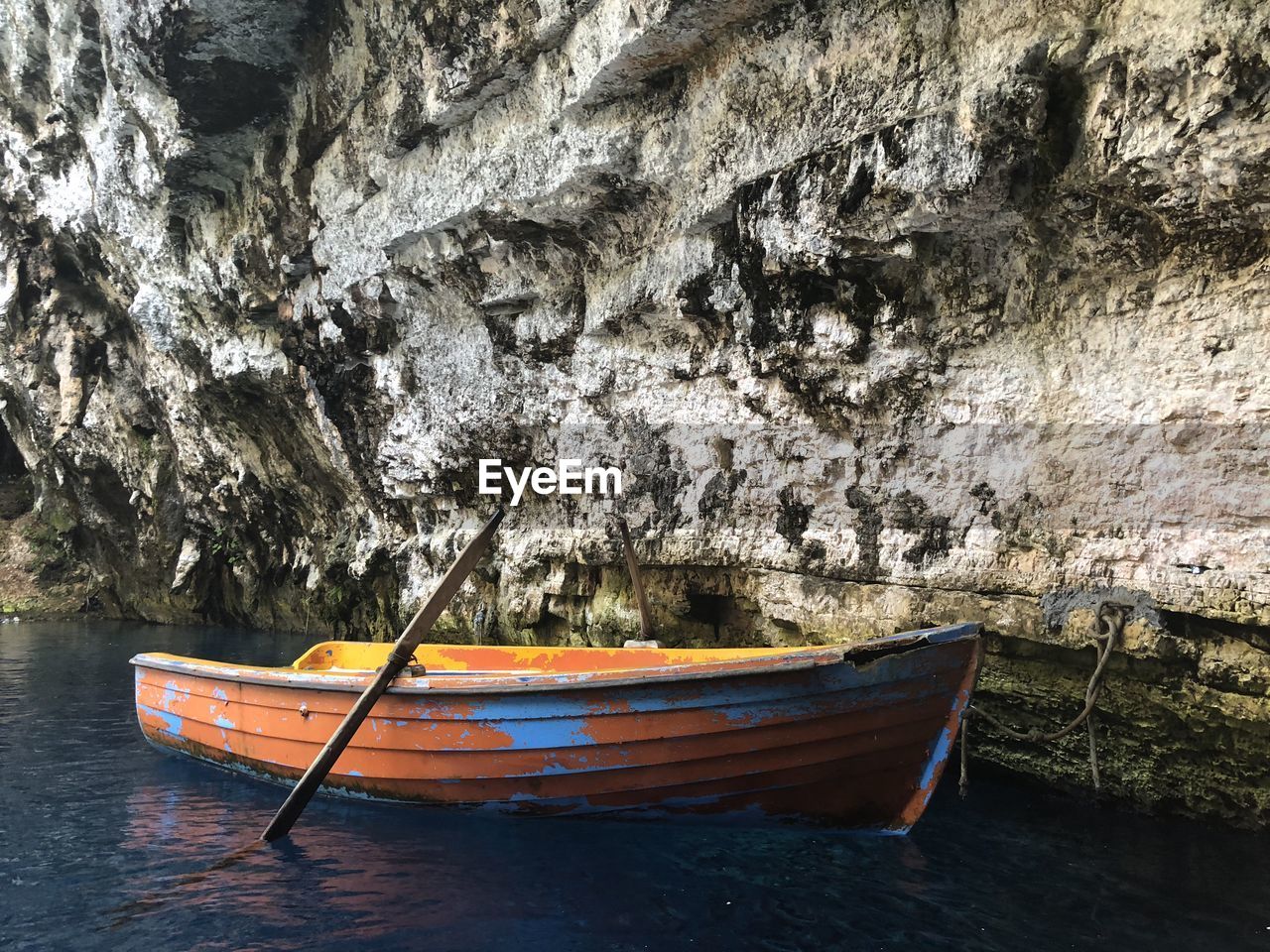 BOAT MOORED ON SHORE