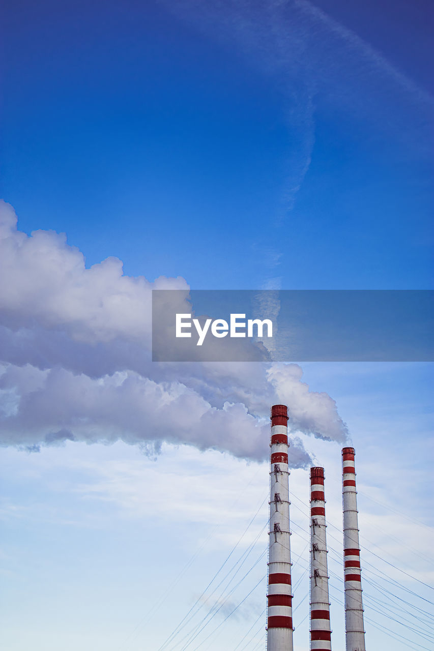 sky, cloud, tower, blue, nature, built structure, architecture, power generation, no people, day, low angle view, industry, technology, outdoors, horizon, building exterior, factory, wind, smoke stack, smoke, environment