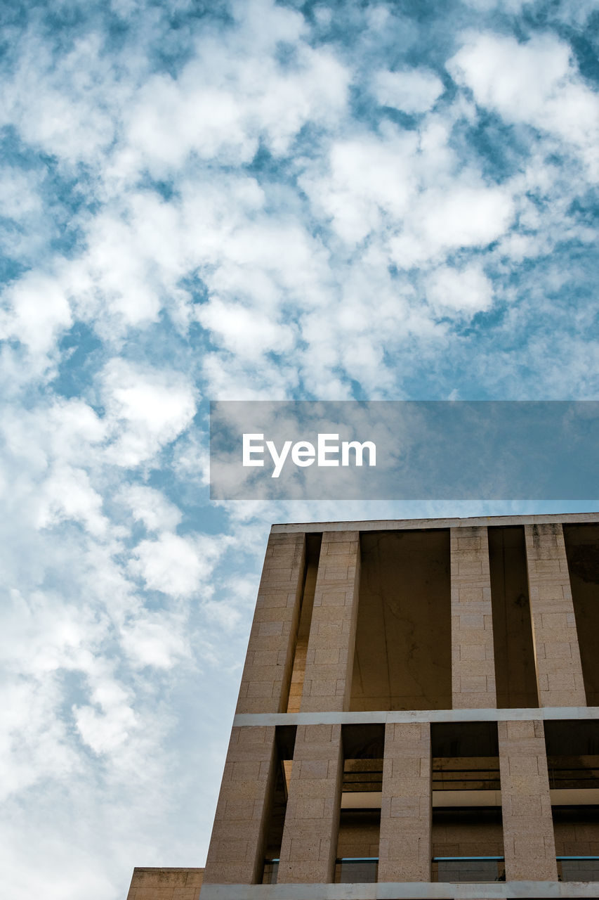 Urban minimal. low angle view of building against cloudy sky