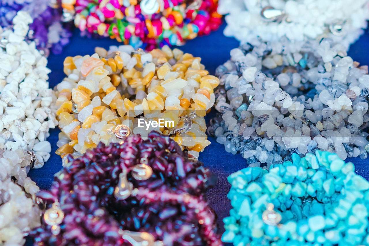 CLOSE-UP OF MULTI COLORED CANDIES ON TABLE