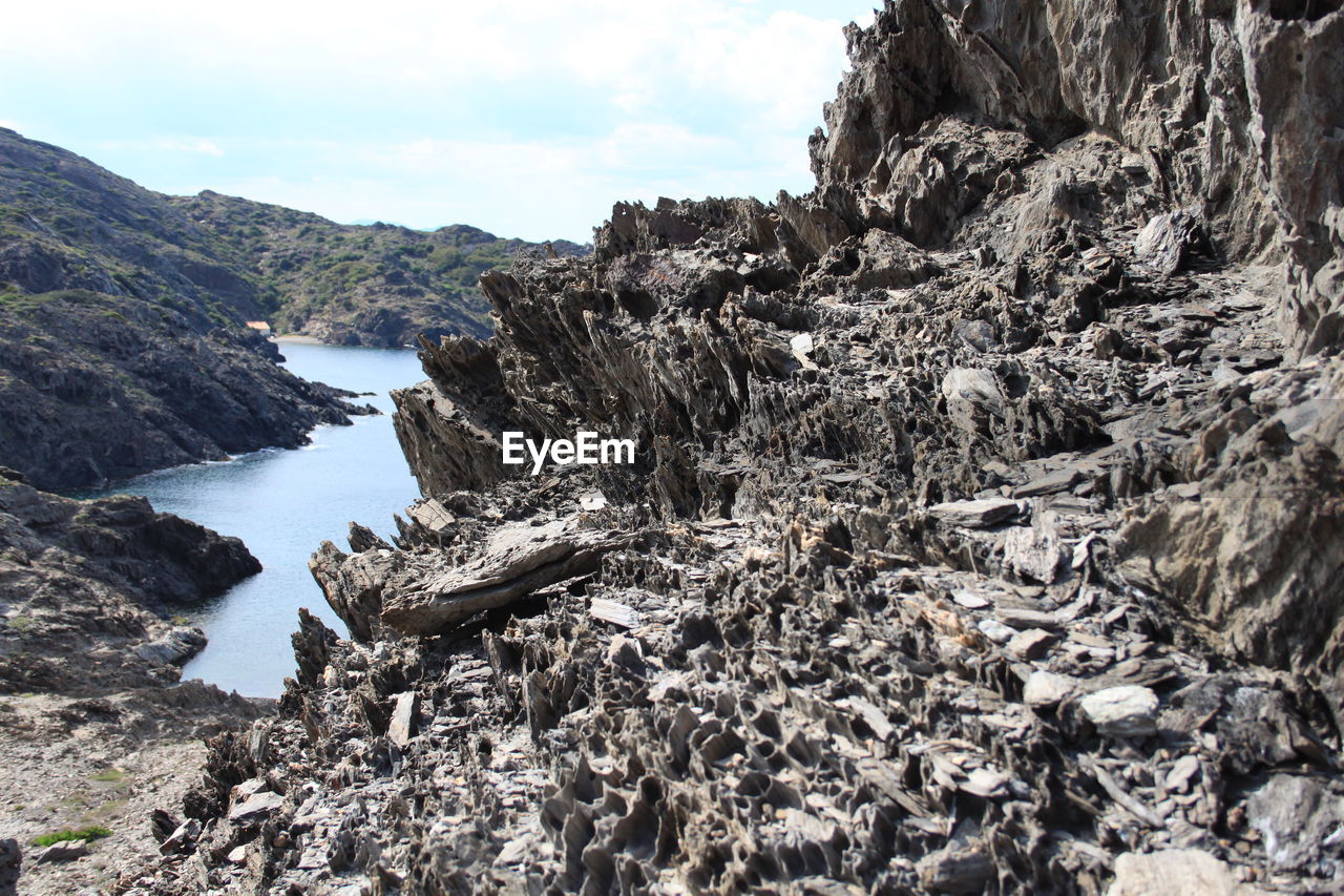 Panoramic view of rocks on beach against sky