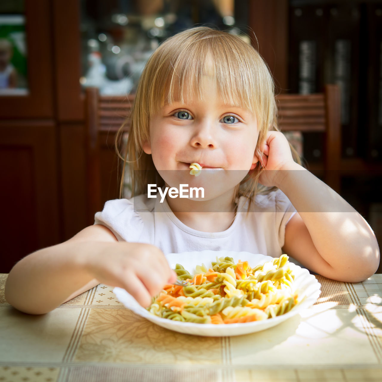 Portrait of girl eating pasta
