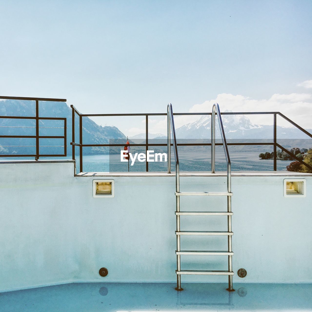 Steps of swimming pool with mountain range in background