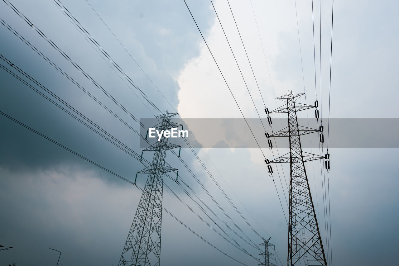 Low angle view of electricity pylon against sky