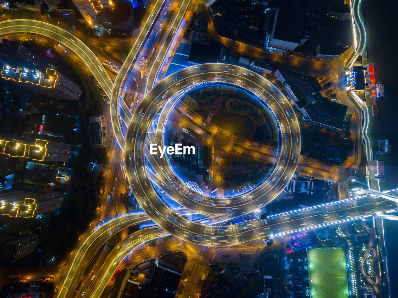 Aerial view of light trails on elevated road in city at night