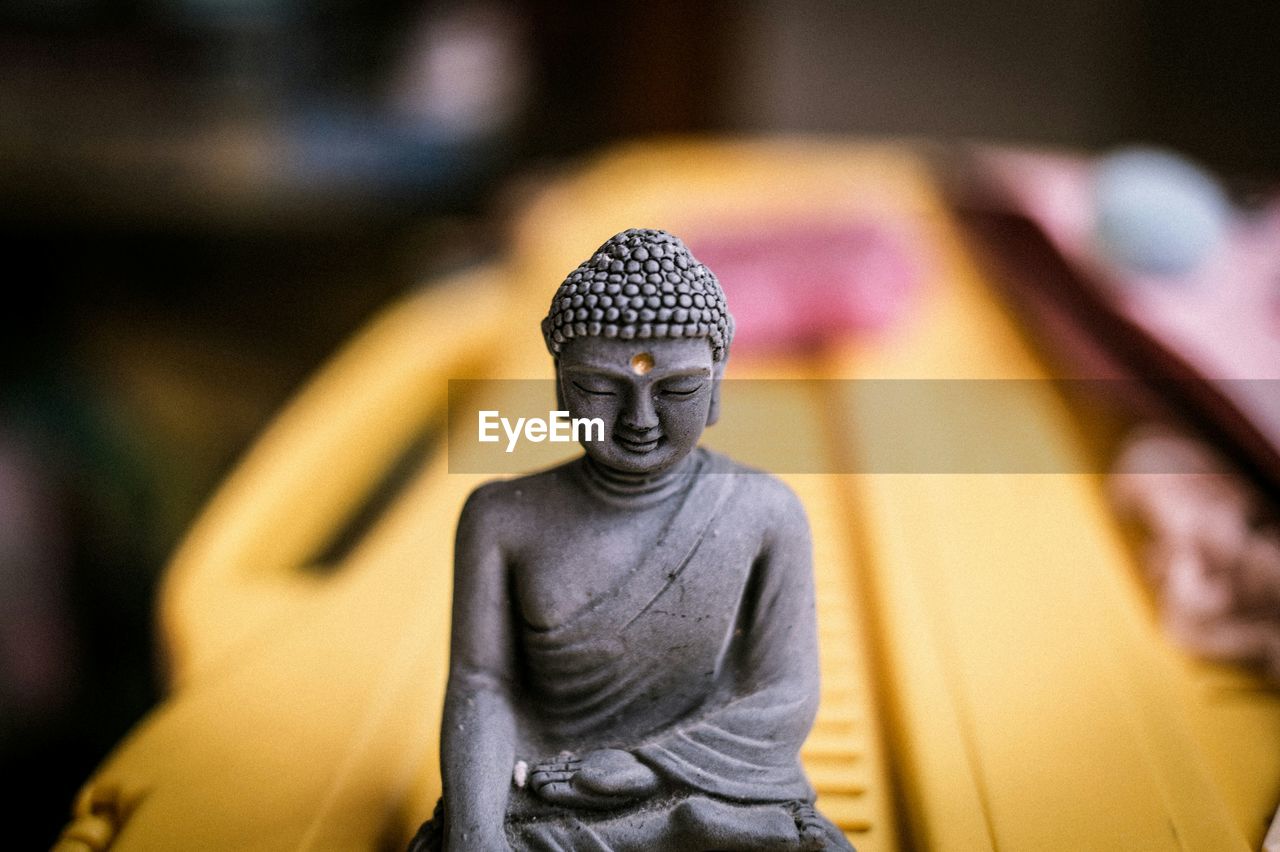 Close-up of stone buddha souvenir