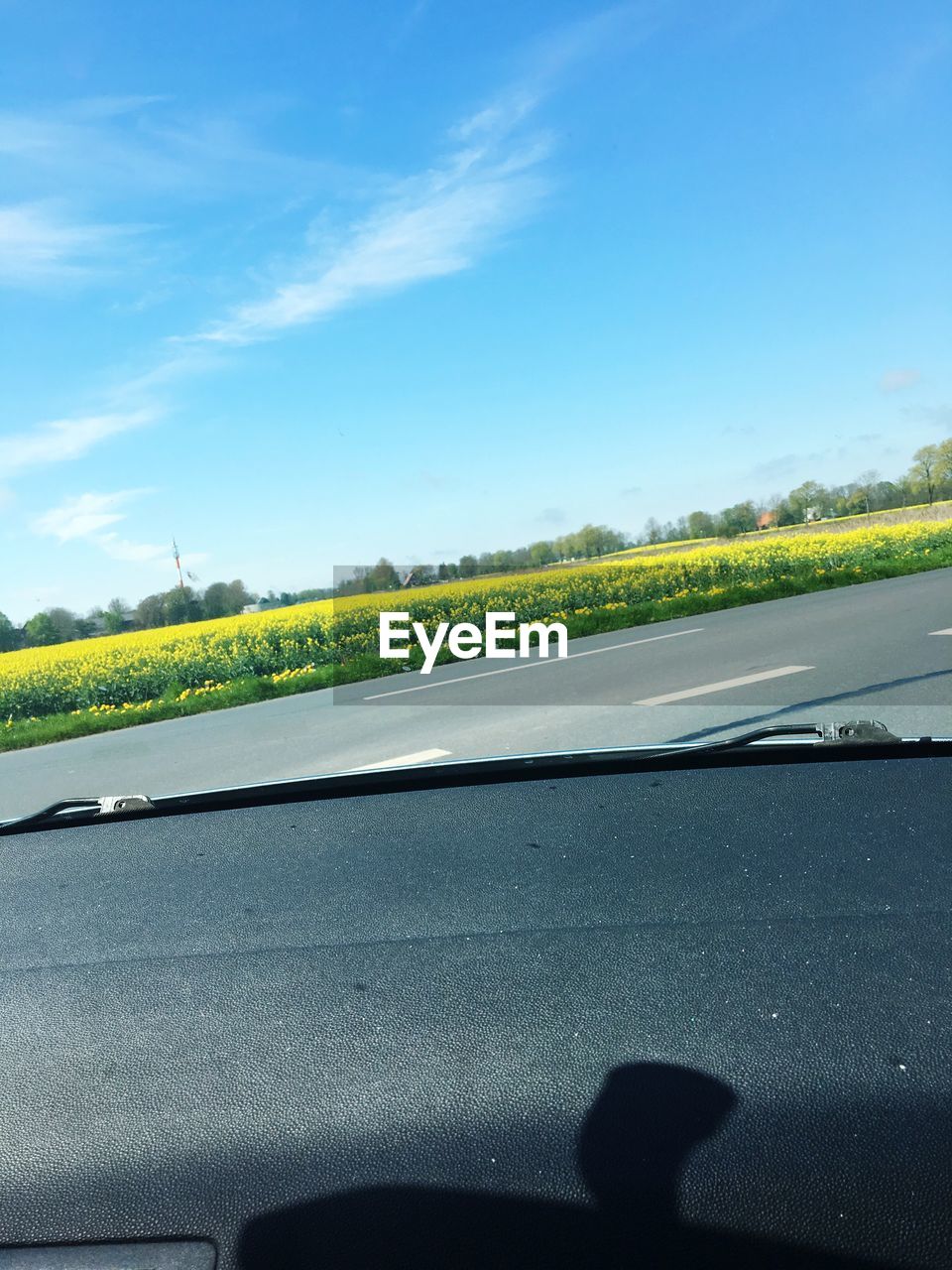 ROAD SEEN THROUGH WINDSHIELD OF CAR