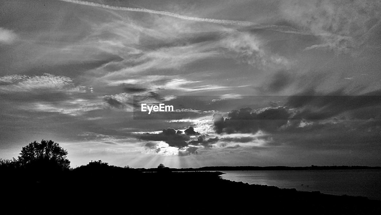 Lake against cloudy sky