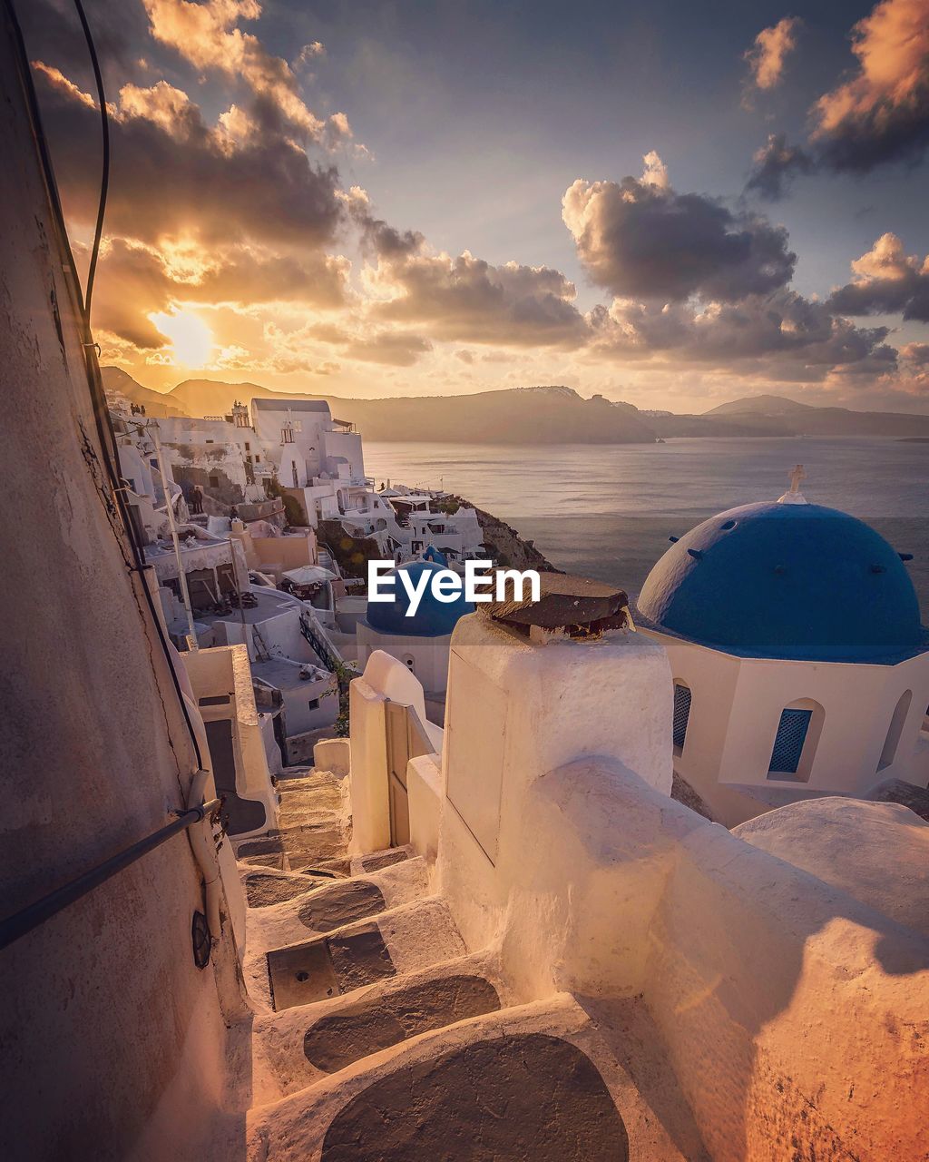 Buildings by sea against sky during sunset at santorini