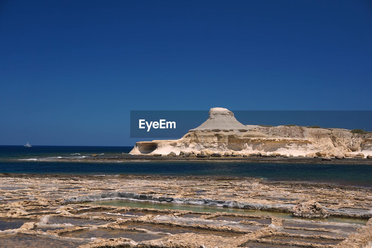 Scenic view of sea against clear blue sky