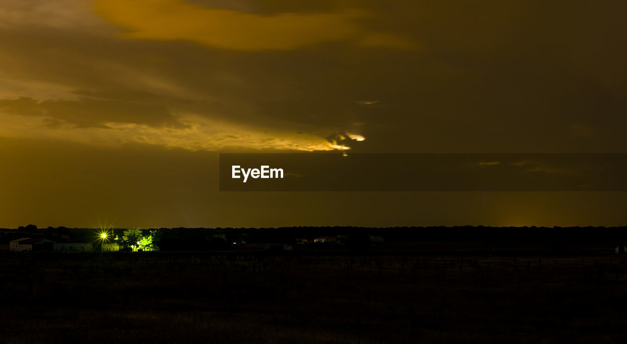 SCENIC VIEW OF DRAMATIC SKY OVER SILHOUETTE LANDSCAPE