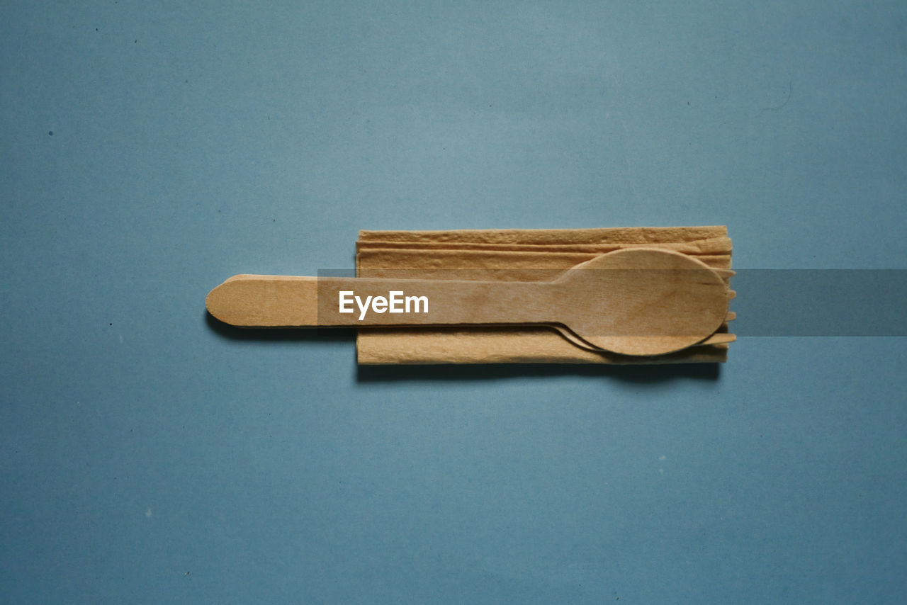 HIGH ANGLE VIEW OF WOODEN TABLE AGAINST BLUE SKY