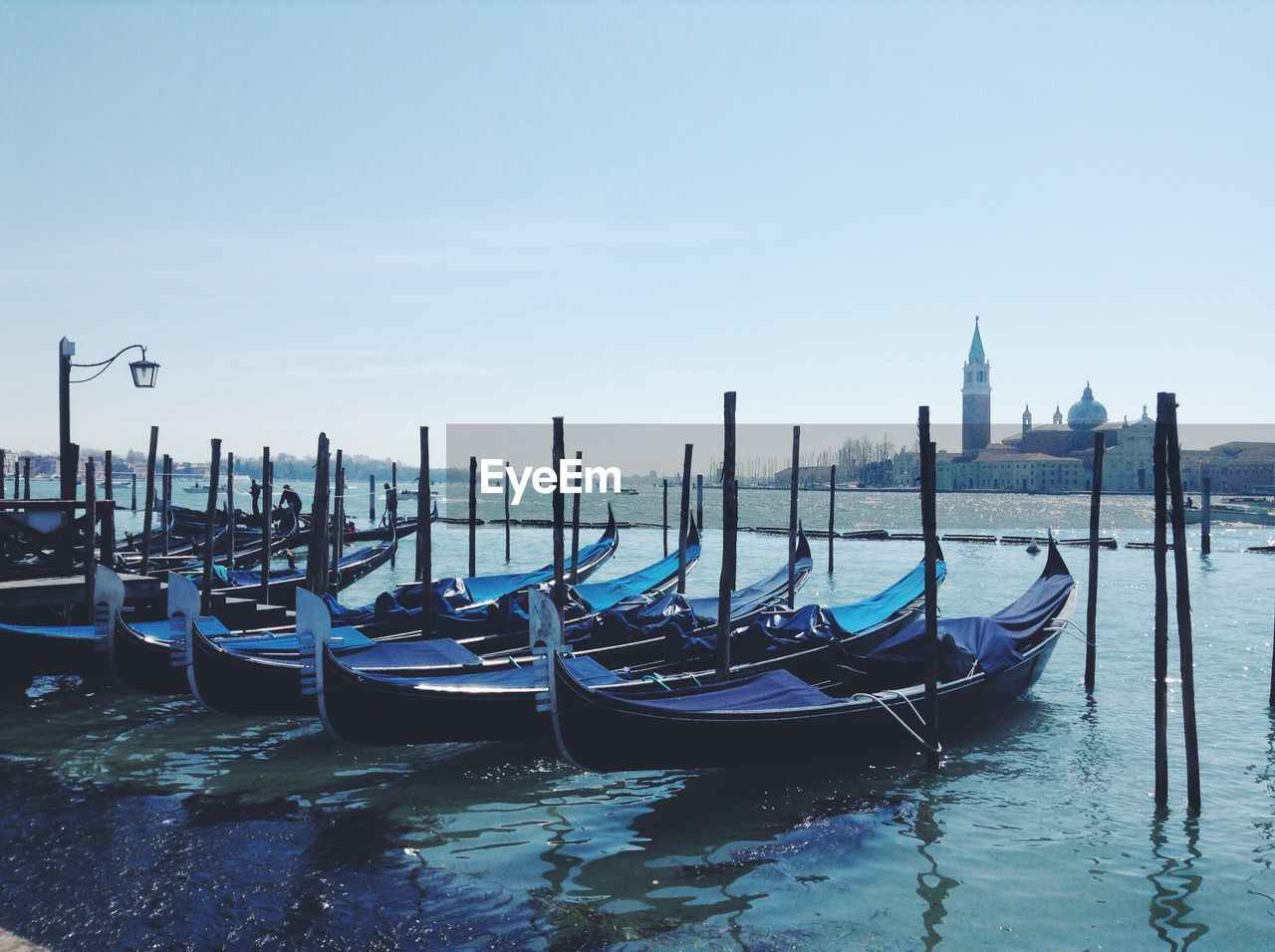 Gondolas moored in river