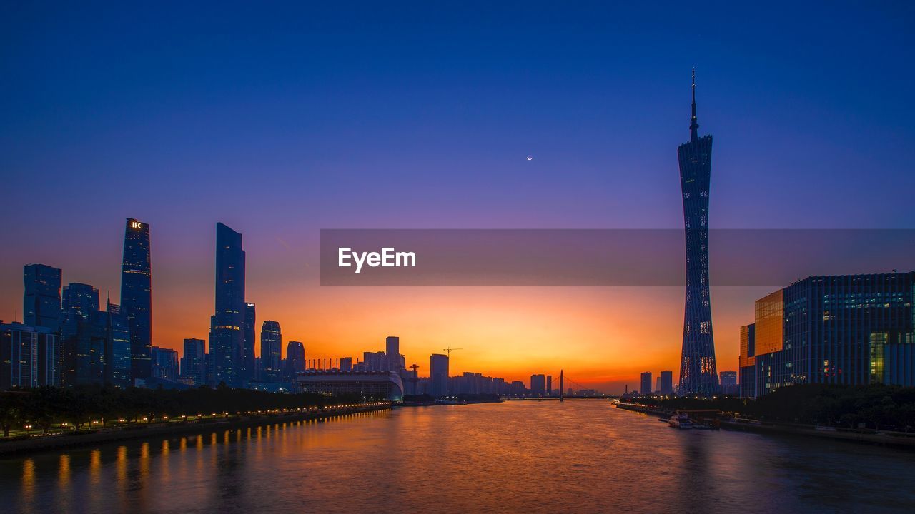 Buildings in city against sky during sunset