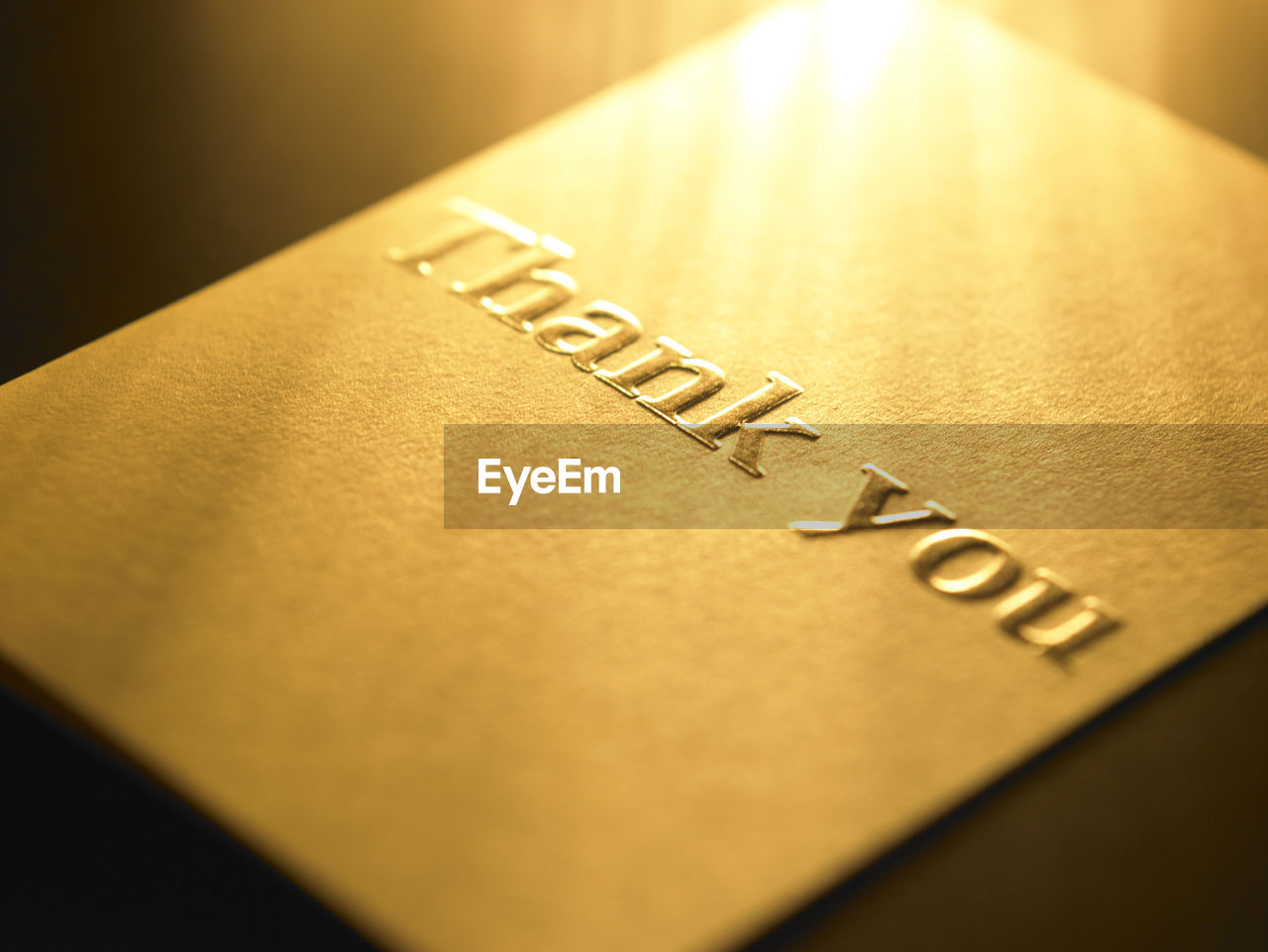 Close-up of thank you card on table