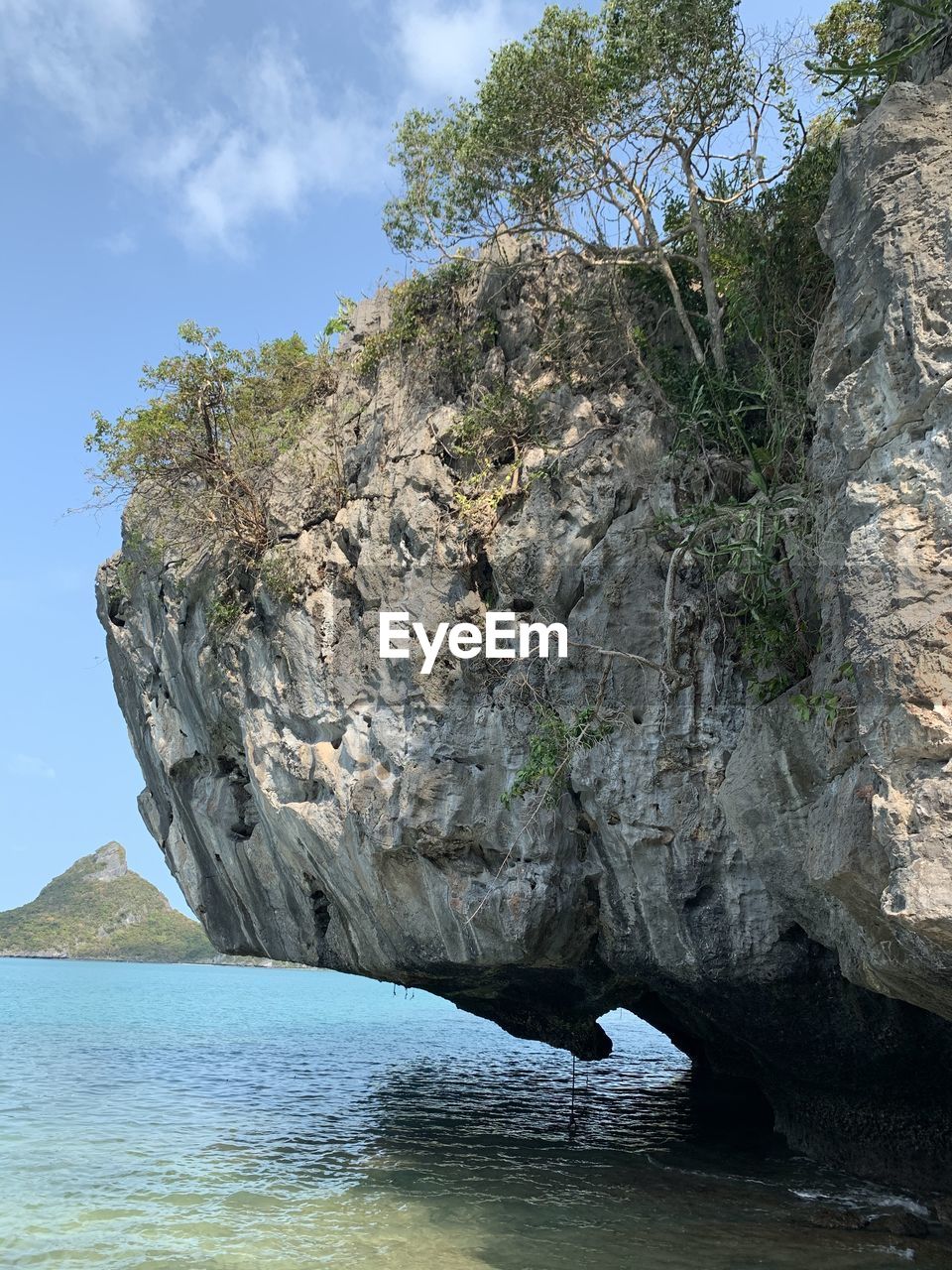 Rock formation by sea against sky